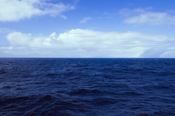 Fototapeta premium The blue sky and ocean meet in the Drake Passage.