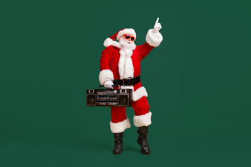 Full length photo of fat funky santa claus with white beard listen x-mas christmas music boom box dance wear sunglass headwear cap isolated over bright shine color background