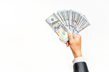 Businessman's hand holding dollars in cash on white background. Copy space