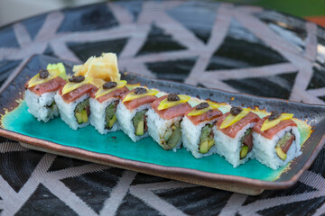 Sushi is a Japanese dish of prepared vinegared rice, usually with some sugar and salt, accompanied by a variety of ingredients.