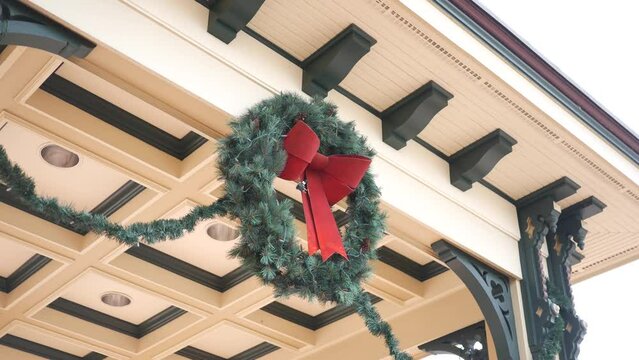Christmas Wreath hanging off building pavilion overhang
