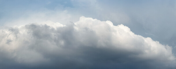 A big white and gray cloud in a dark stormy sky