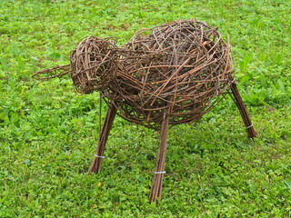 A sheep sculpture made of wicker. Garden decoration elements. Fun and creative pastime. Animal sculptures from willow © Gunars