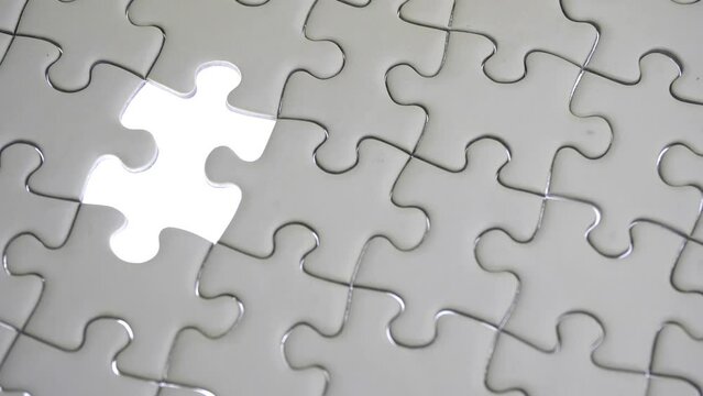 Hand holding jigsaw puzzle last missing piece lighting. 
Concept last piece of jigsaw puzzle for problem and 
completion.