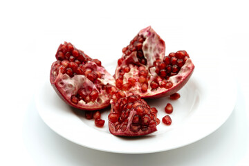 Opened juicy pomegranate fruit isolated on white background. Red pomegranate, healthy food