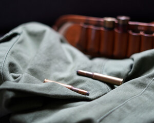 Hunting equipment. Leather stock for cartridges, green pants and cartridges.