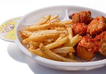 French fries on a white plate on a white background