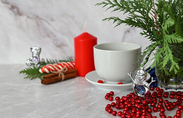 Merry christmas, happy new year theme. Composition from branches of a natural Christmas tree and red balls, decoration on a background of light wooden boards. Top view.Place for your text.