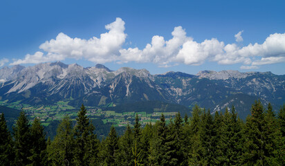 a hiking trail overlooking the beautiful alpine landscape with vast green alpine valley in the Austrian Alps of the Schladming-Dachstein region (Steiermark, Austria)