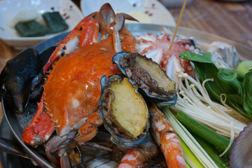 Steamed dish with various vegetables, octopus, abalone, and seafood