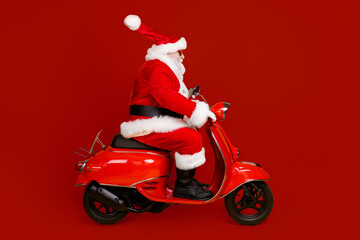 Profile side view of his he nice funny fat thick white-haired Santa riding motor bike fast speed...
