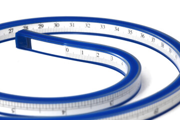 Flexible curve vinyl plastic ruler or measuring lead with centimeter and inch indicator. Concept of measurement. Isolated on white background. Slightly de-focused and close-up shot. Copy space.
