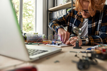 Man connect wires and cables on electro equipment