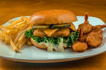 fish fillet sandwich  with a side of  butterfly shrimp and fries