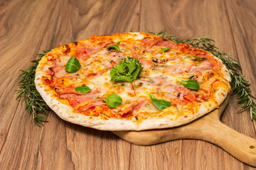Italian pizza Capricciosa  with cheese, tomato sauce and basil