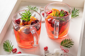 Hot Christmas punch in a glass with spices and fruits.
