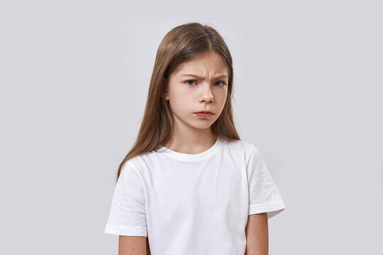 Little girl with skeptical face looking at camera
