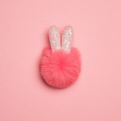 Pink fluffy rabbit on a pink background. Christmas concept.