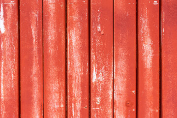 Background of a red weathered slats of a metal building.