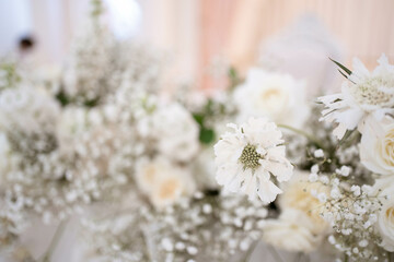 Main table at a wedding reception with beautiful fresh flowers and candles.