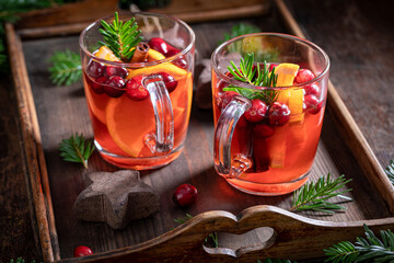 Sweet Christmas punch with orange, cranberry and cinnamon,