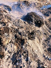 Garbage heap burnt waste pile on fire trash smoke rubbish burning ashes air pollution dump litter dirty garbage-pile solid rubbish scrap refuse waste-material debris household-waste environment photo 