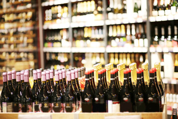 defocused alcohol (wine, champagne, liquor, whiskey) on store shelves