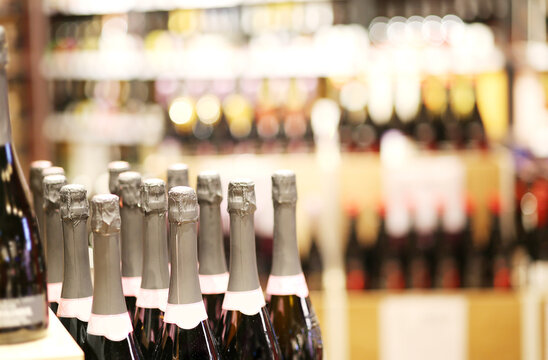 defocused alcohol (wine, champagne, liquor, whiskey) on store shelves