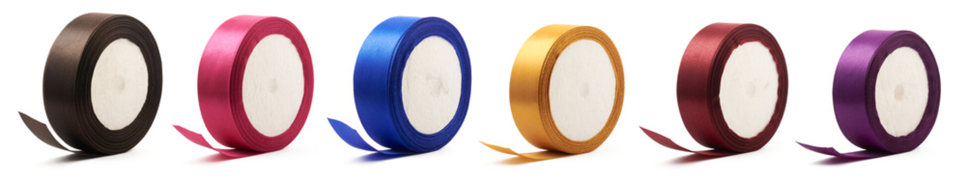set of colorful satin ribbon spools, close-up of textile ribbon reels isolated on white background, collection