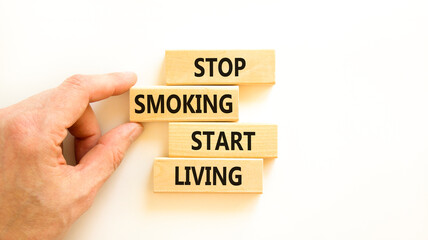 Stop smoking start living symbol. Concept words Stop smoking start living on cubes. Beautiful white background. Doctor hand. Medical healthy lifestyle stop smoking start living concept. Copy space.