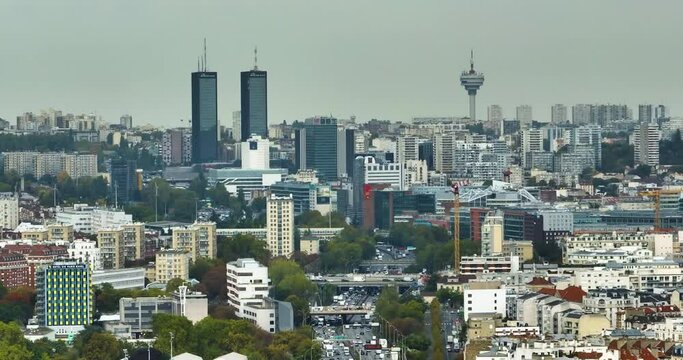 View from a flying drone over the city of Paris. Cityscape of the most popular city in the world. Roofs of houses and skyscrapers on the horizon line. Cinematic shot from a drone