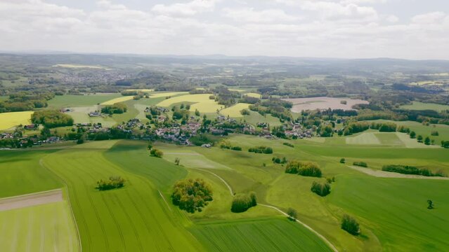 Aerial landscape view with a beautiful greenfield and high trees in Germany