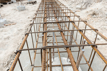 Monolithic foundation with metal reinforcement. Reinforcement construction mesh. Concrete pile foundation after completed for new construction site. The construction tool for monolithic works.