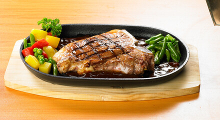 grilled beef steaks with spices on wooden cutting board