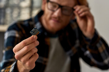 Focus of microchip in hand of partial engineer