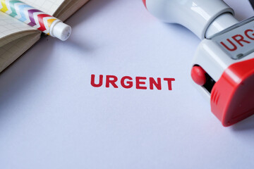 Red URGENT word stamp on a white paper 