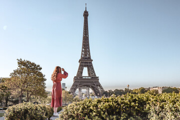 Woman next to the Eiffel Tower.