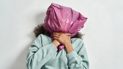 Black girl with danger plastic bag on her head