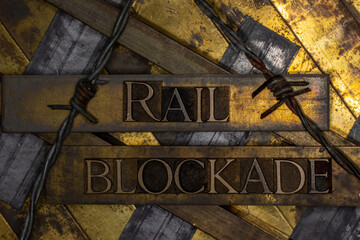 Rail Blockade text over railroad tracks with barbed wire on vintage textured copper and gold background