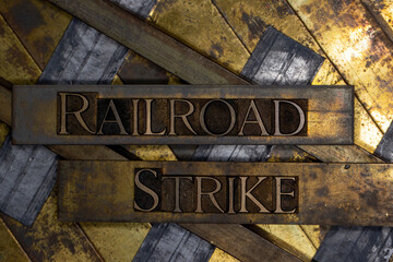Railroad Strike text over railroad tracks on vintage textured copper and gold background