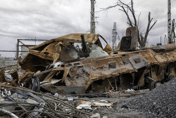 Fototapeta premium burnt tank and destroyed buildings of the Azovstal plant shop in Mariupol
