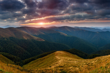 Amazing panoramic mountains landscape at dawn. View of dramatic morning sky and mountain ridges and slopes.