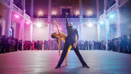 Couple dancers  perform latin dance on large professional stage. Ballroom dancing.