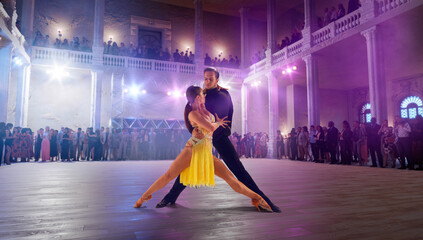 Couple dancers  perform latin dance on large professional stage. Ballroom dancing.