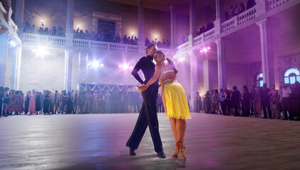 Couple dancers  perform latin dance on large professional stage. Ballroom dancing.
