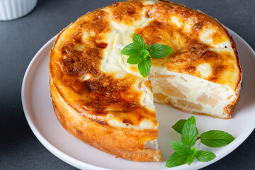 Baked Sweet Cottage Cheese casserole with apple decorated mint