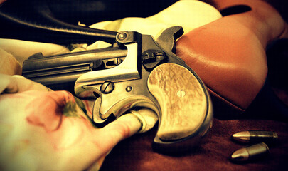 A double barrel derringer style pistol with high heels and a nighty in sepia tones. This kind of...