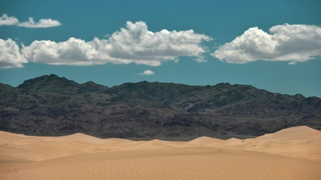 Timelapse video of sand dunes, mountains and clouds. South Gobi desert, Gobi Gurvan Saihan
