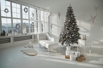 huge white cyclorama studio flooded with sunlight with New Year decoration for Christmas holidays