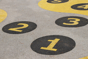 Children's game with numbers in circles on the playground on the roads for jumping in Ukraine, playground, game